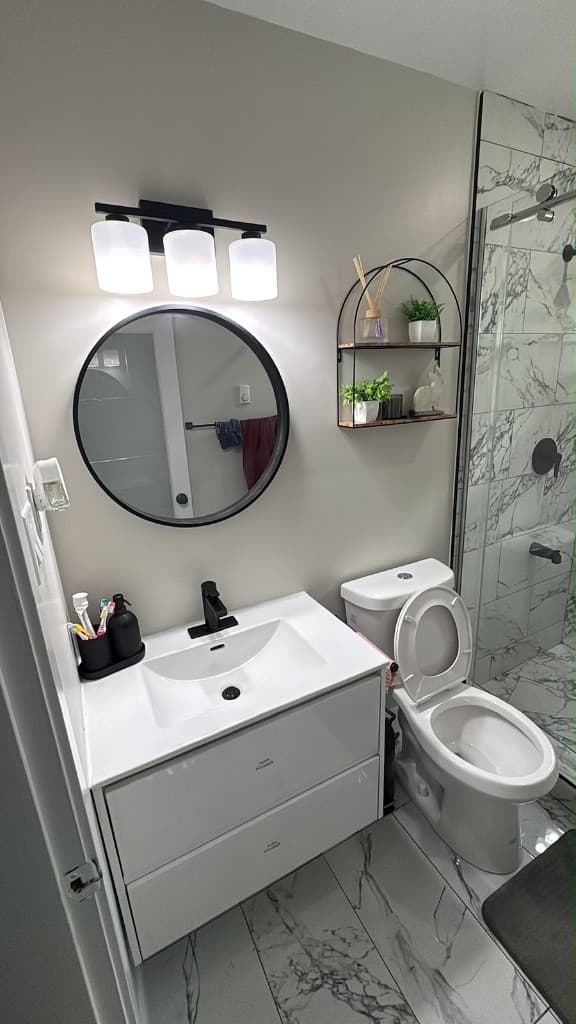 Completed bathroom renovation by Right On Contracting — vanity, mirror, and tiled shower